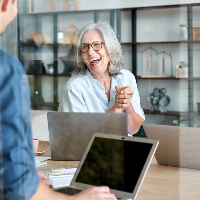 A happy mature woman mentoring someone